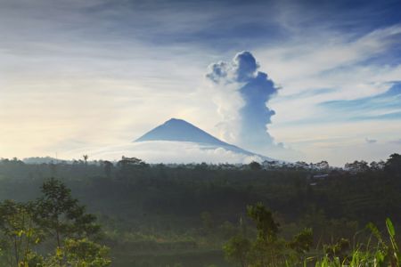 What makes a dormant volcano erupt?