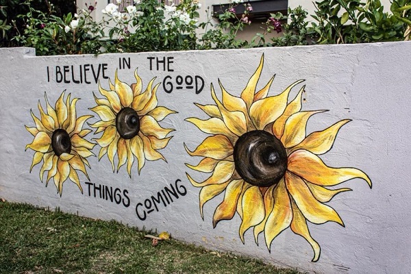 Article image for ‘The Sunflower Girl’ painting Perth and spreading brightness one mural at a time