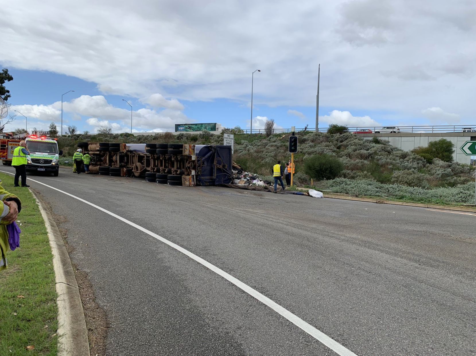 Article image for Rubbish truck loses load on Perth highway causing traffic chaos