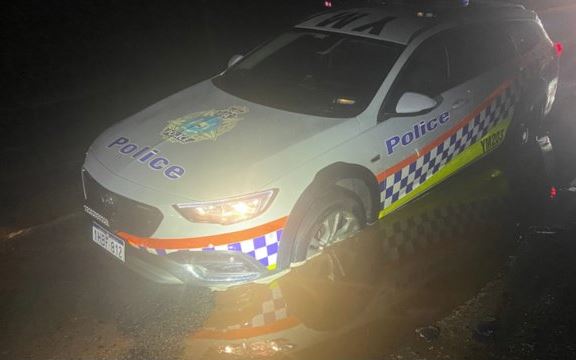 Article image for Police car gets stuck in sink hole on country highway