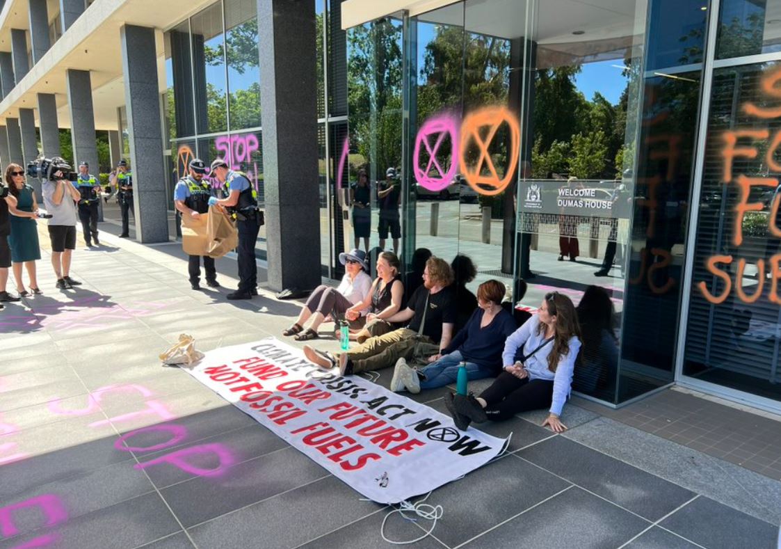 Article image for WATCH: Extinction Rebellion activists glue hands to ground outside McGowan’s office