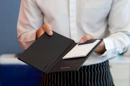 Restaurant customer frustrated over tip being added to his bill without asking